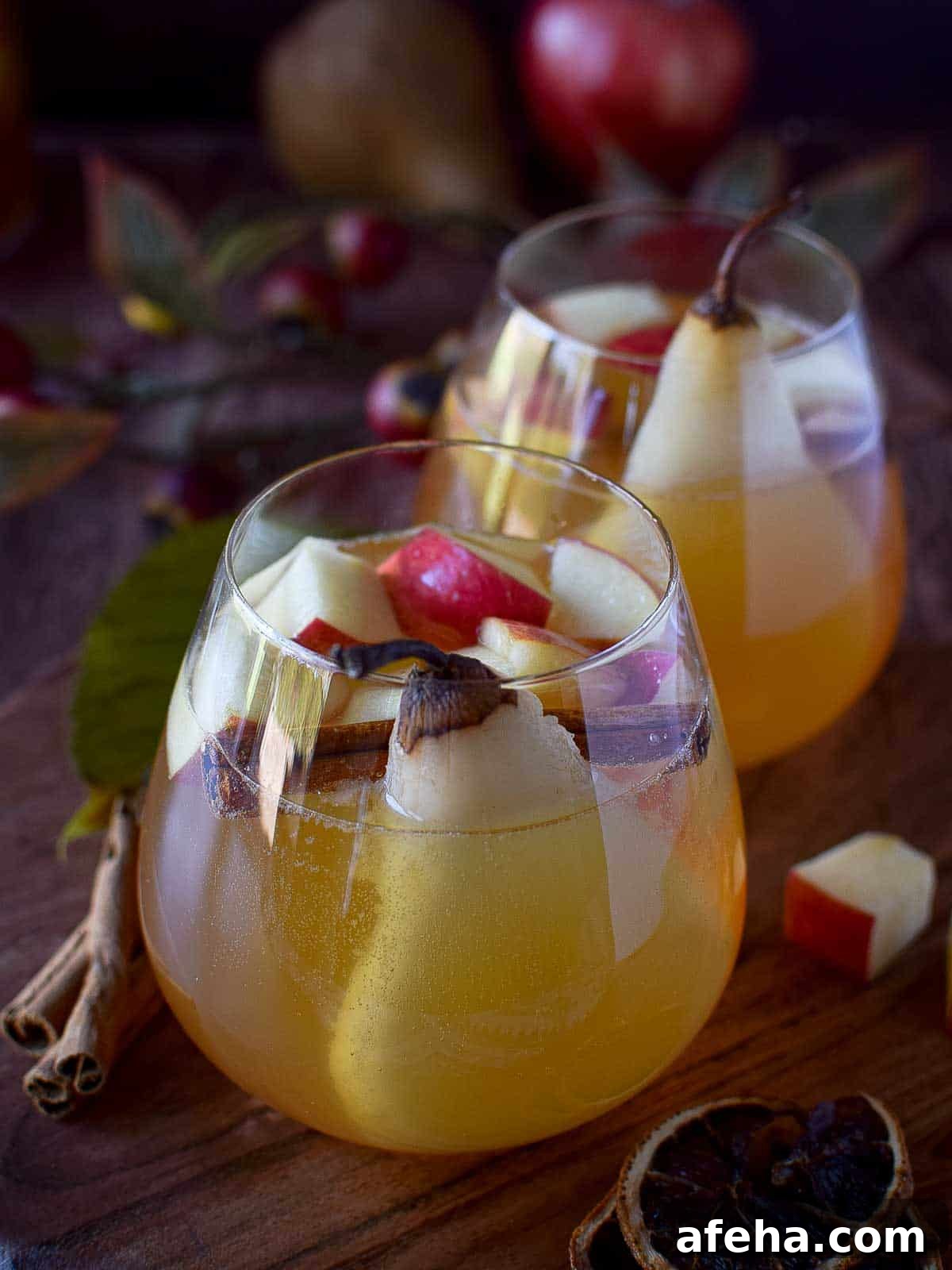 Spiced Apple & Pear White Sangria Recipe for Fall Gatherings 4 Close-up of two glasses of apple and pear sangria.