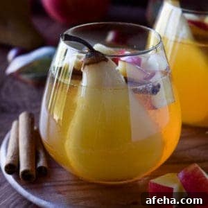 Spiced Apple & Pear White Sangria Recipe for Fall Gatherings 9 Close-up of apple and pear sangria in a glass.