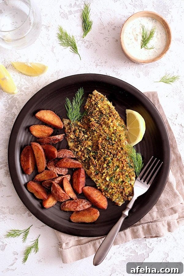 Pistachio-Crusted Fish with Lemon-Dill Aioli 2 Photo of Pistachio-Crusted Fish with Lemon-Dill Aioli on black plate with roasted potatoes.