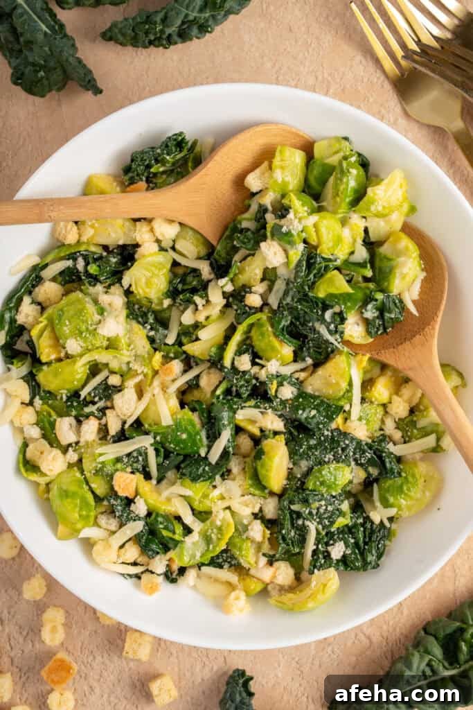 White Bowl with green warm kale and brussel sprouts with shredded cheese and crunchy croutons.