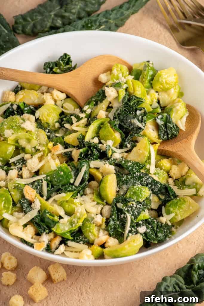 White Bowl with green warm kale and brussel sprouts with shredded cheese and crunchy croutons.