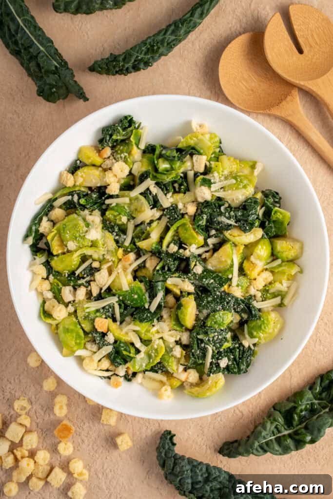 White Bowl with green warm kale and brussel sprouts with shredded cheese and crunchy croutons.