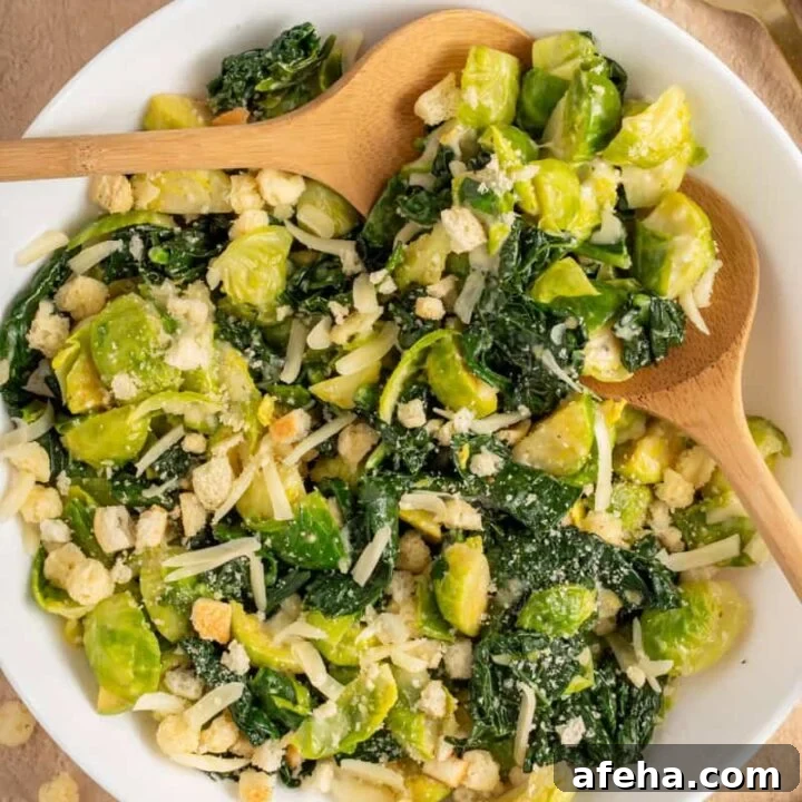White Bowl with green warm kale and brussel sprouts with shredded cheese and crunchy croutons.