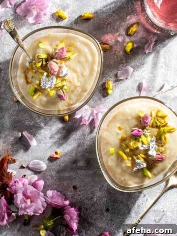 Firni in two bowls surrounded by flowers and petals.