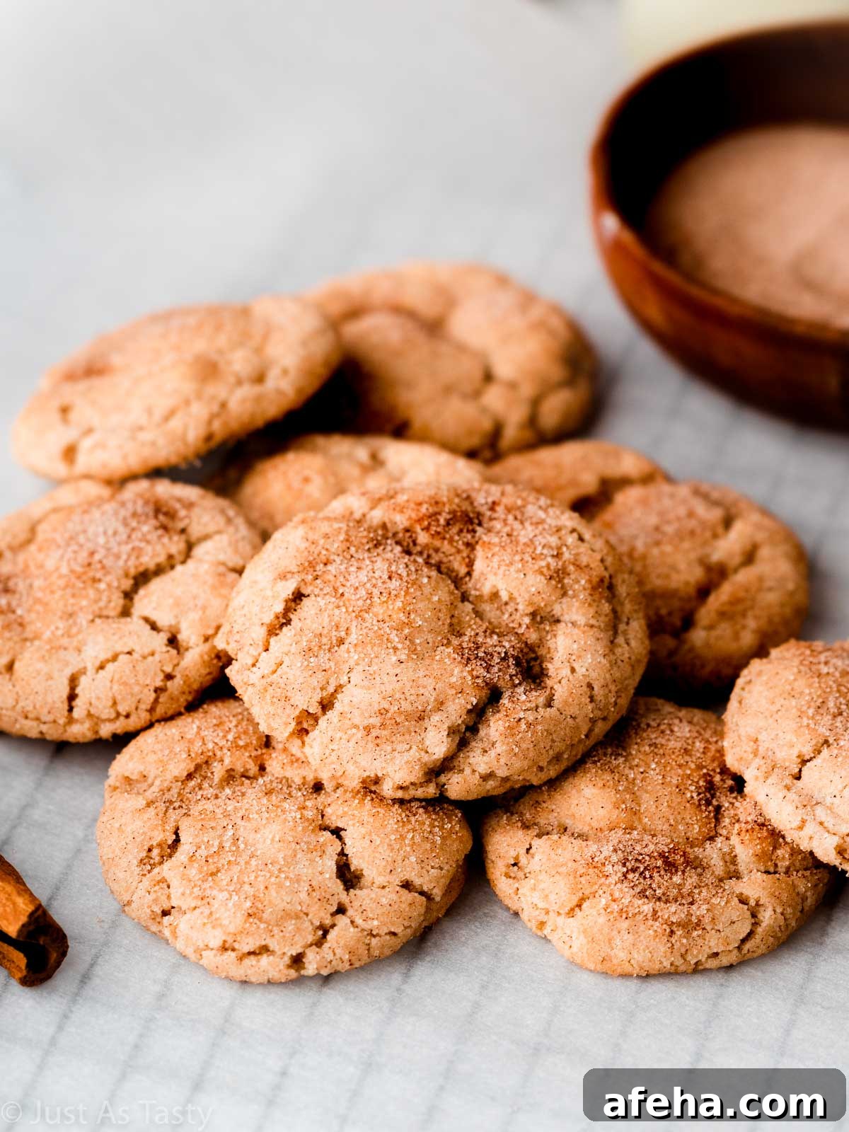 Pile of gluten free snickerdoodles on parchment. 