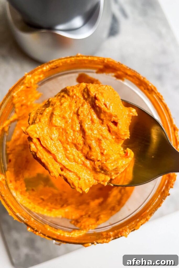 Spicy feta dip on a gold spoon.