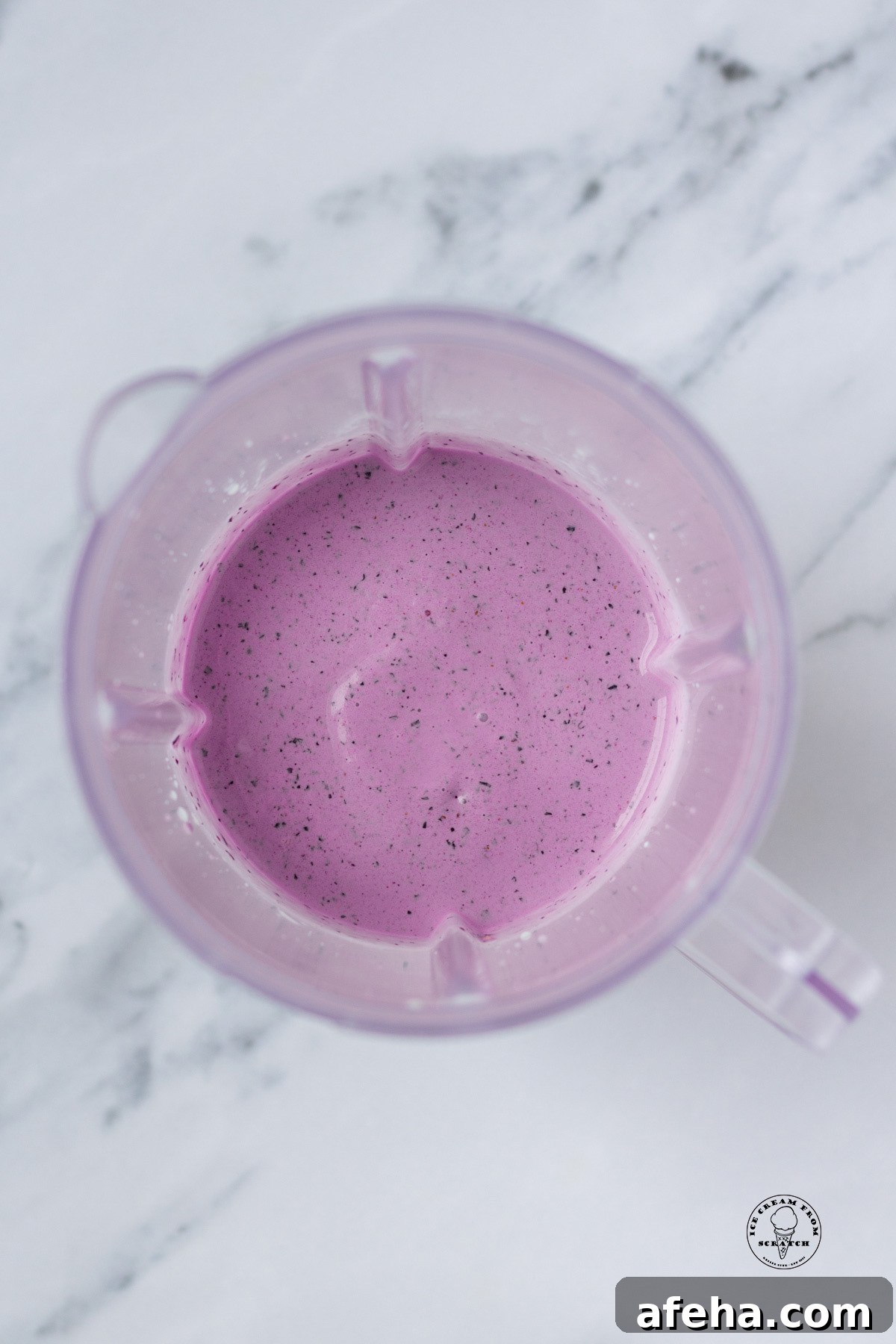 view from above of a blueberry milkshake in a blender jar