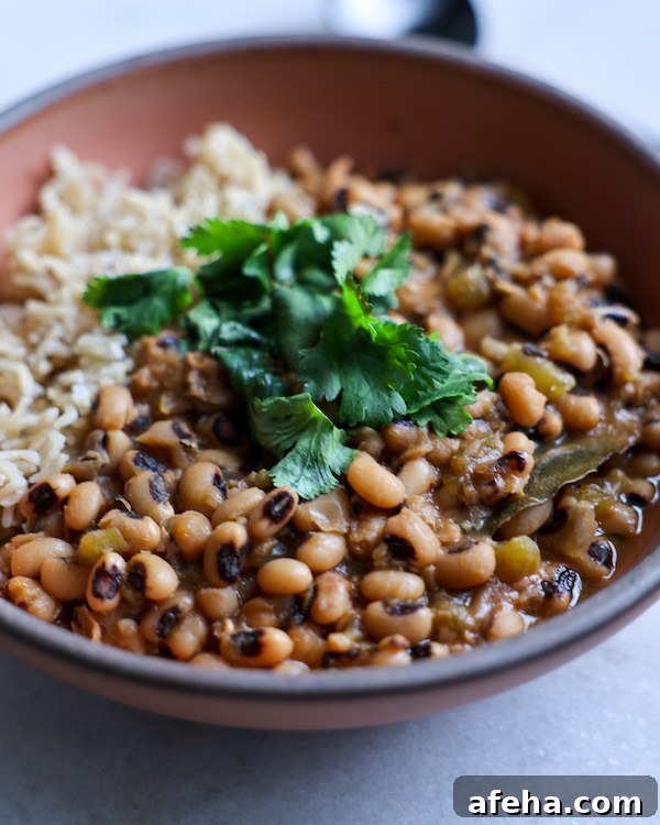 A close-up shot of a bowl of black eyed peas and rice.