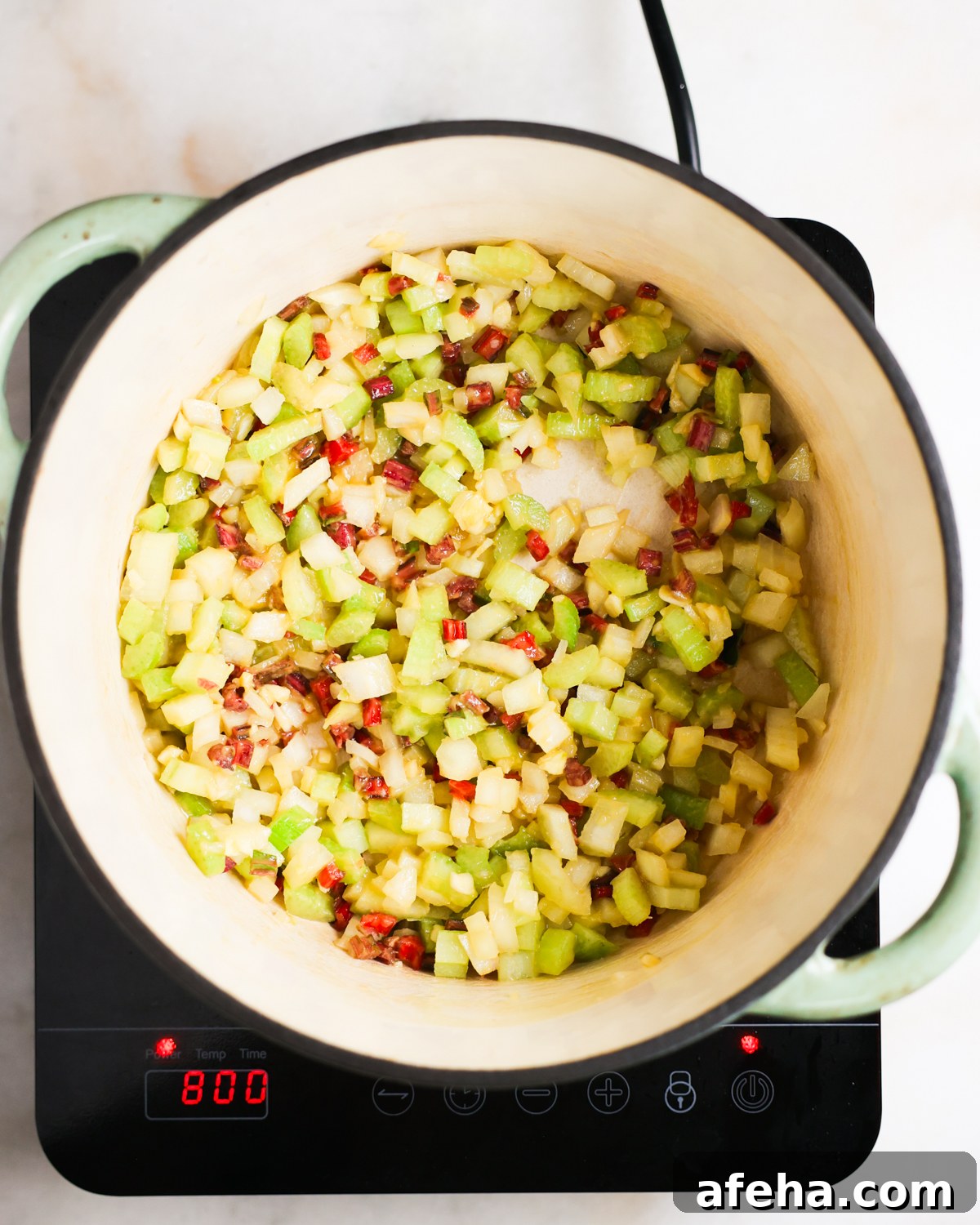overhead of aromatics sautéing in a pot