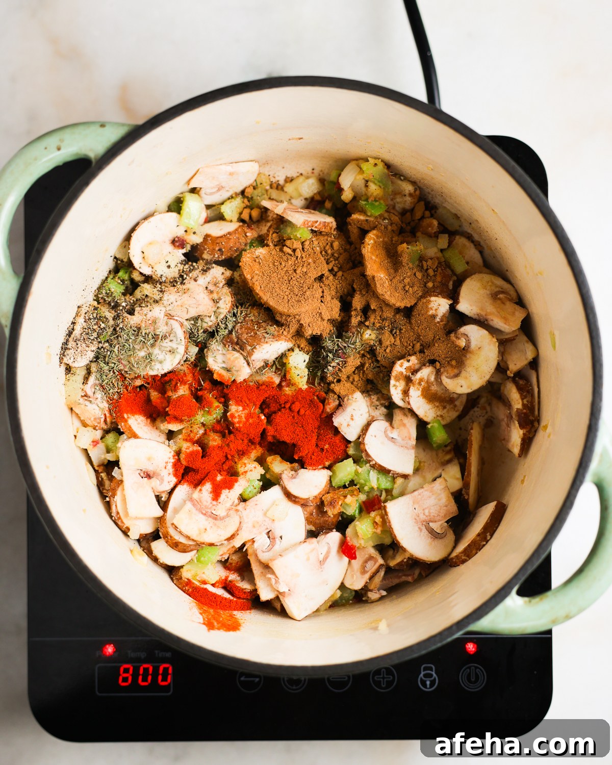 stirring mushrooms and spices in pot