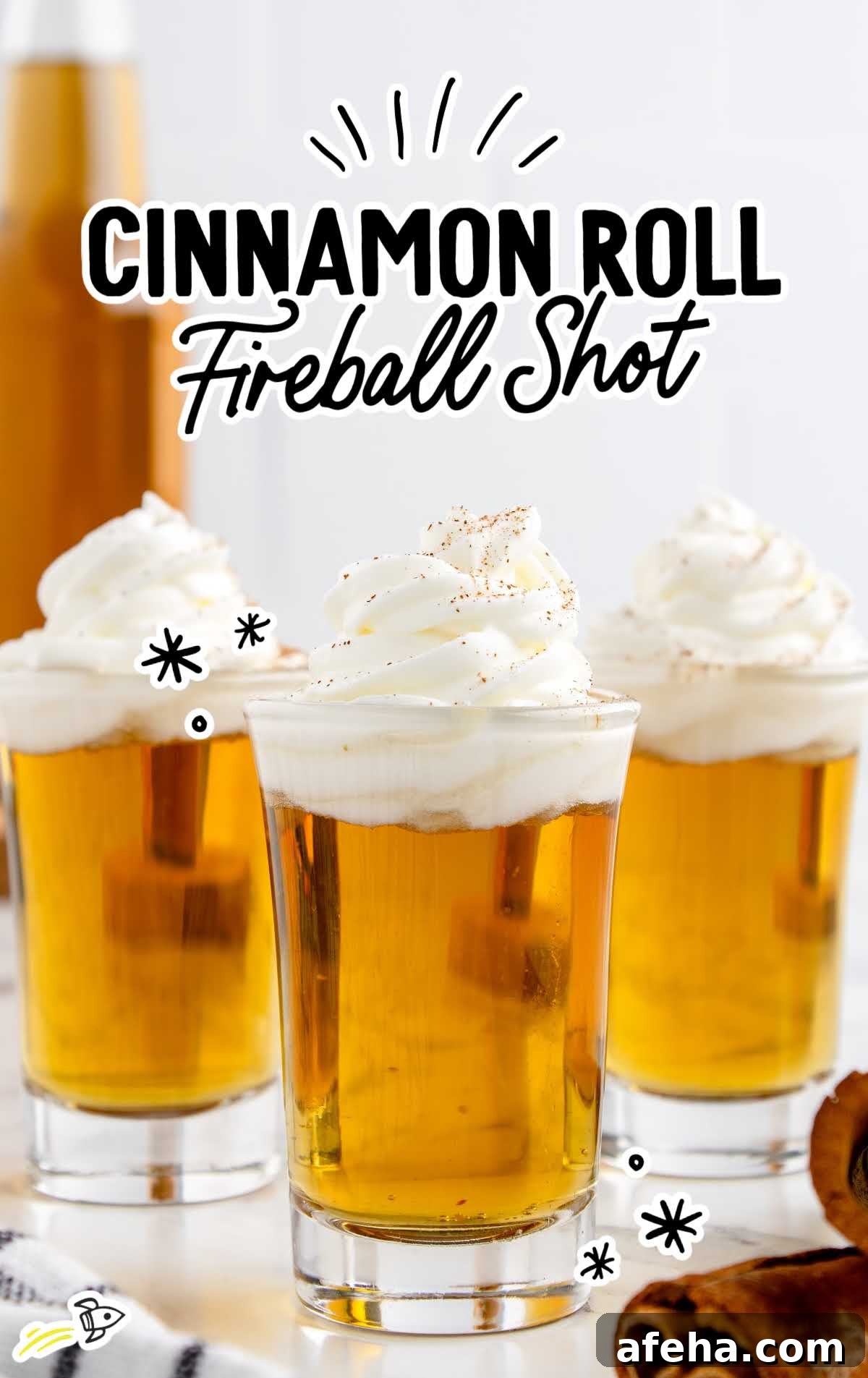 a close up shot of Cinnamon Roll Fireball Shot in cups topped with whipped cream