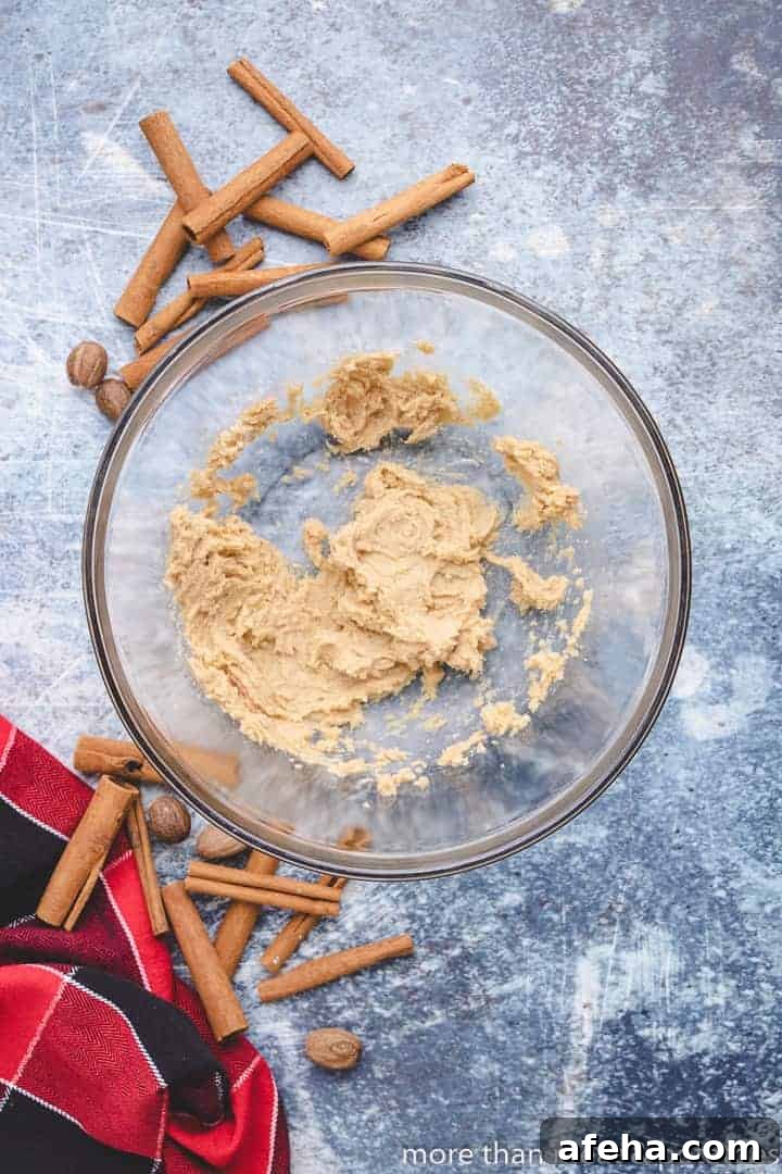 Butter and brown sugar combined in a mixing bowl.