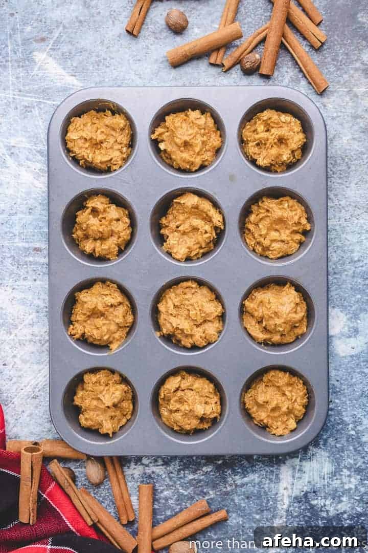 The pumpkin muffin batter transferred to a muffin tin.