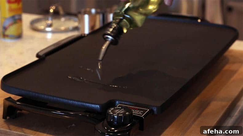 oil being poured on an electric griddle