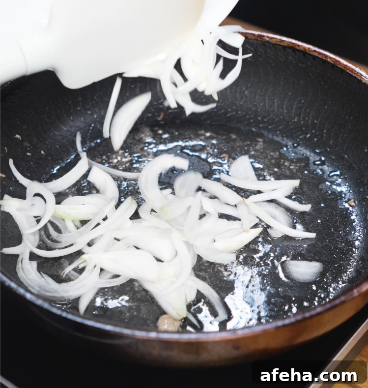Thin slices of onion cook in the same skillet used for pork, soaking up flavor and becoming caramelized and tender.
