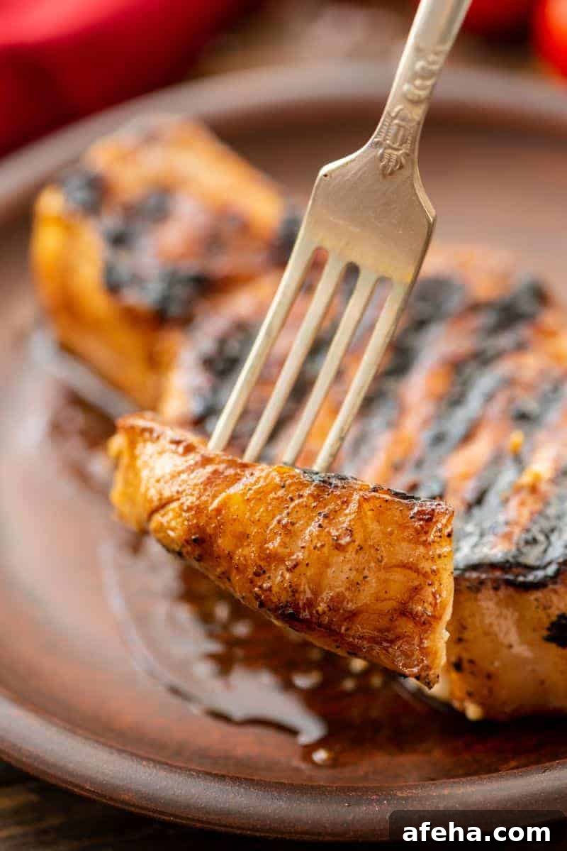 Savory Pork Chop Marinade for Juicy Grilled Pork Chops 6 Piece of Grill-Pork-Chops on fork
