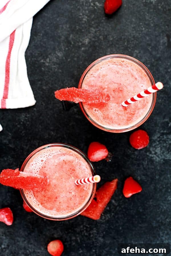 This four ingredient Strawberry Grapefruit Smoothie couldn't be easier! A ruby red grapefruit, strawberries, banana and orange juice are blended together in just seconds to create the perfect easy breakfast or snack.