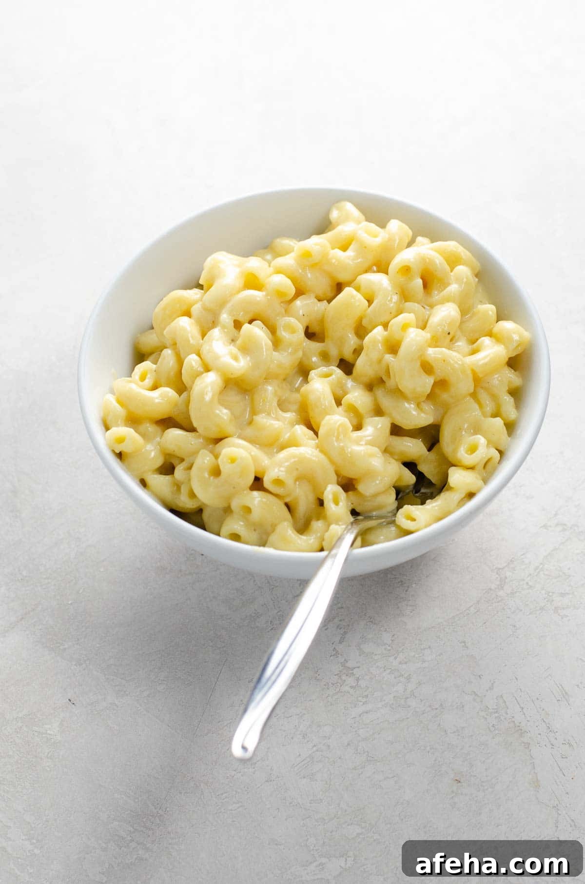 Creamy Instant Pot Macaroni and Cheese Recipe 2 instant pot mac and cheese in a bowl with a spoon