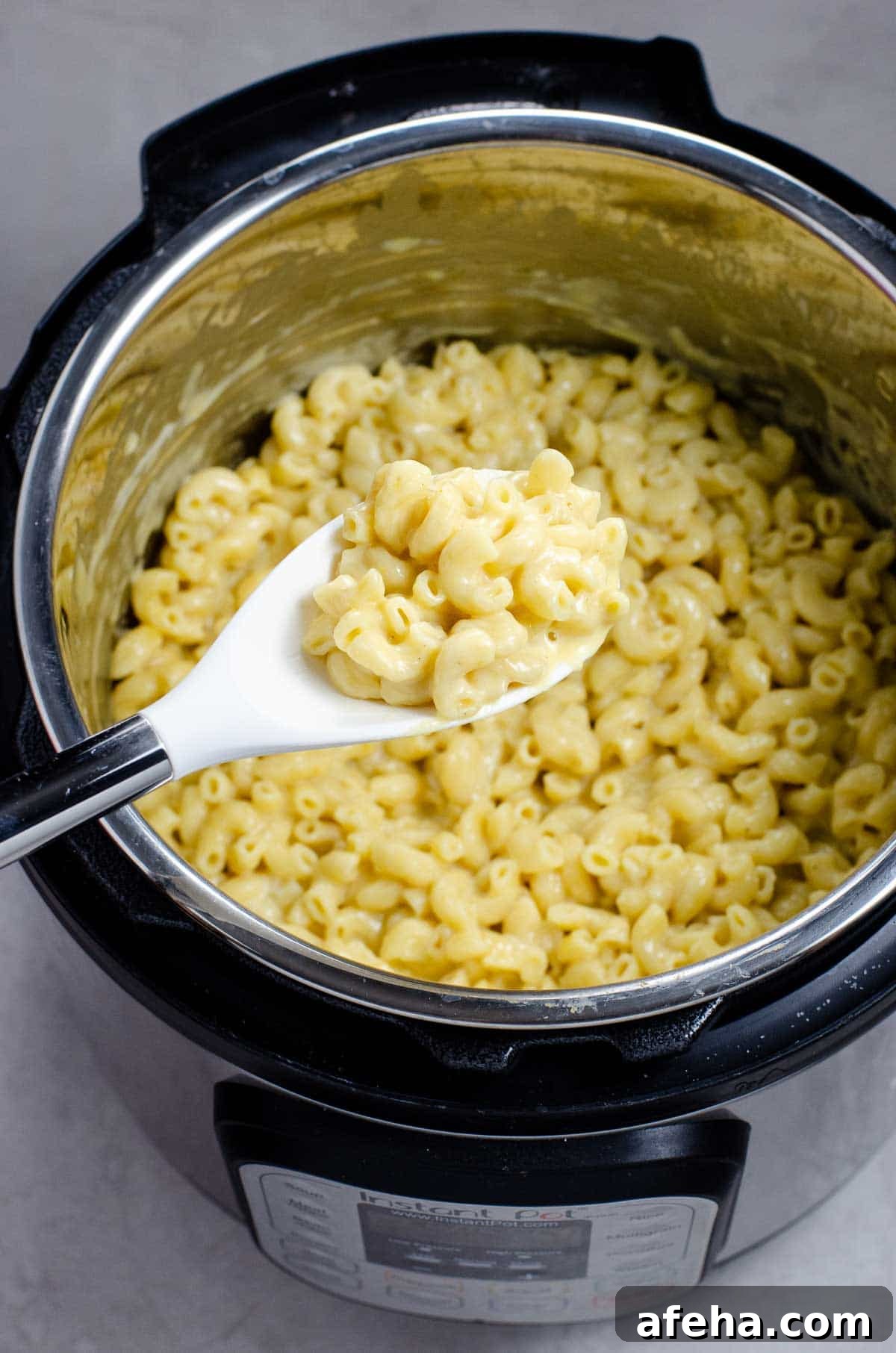 Creamy Instant Pot Macaroni and Cheese Recipe 5 instant pot mac and cheese with a serving spoon