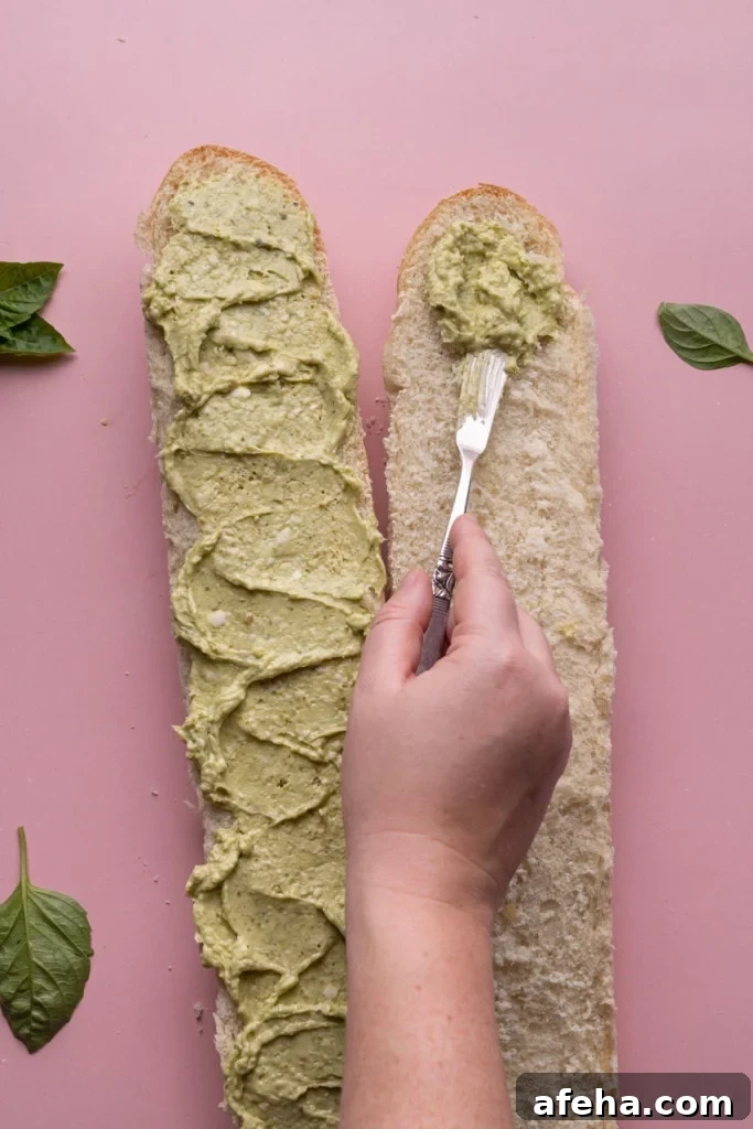 Spreading Pesto Butter on French bread
