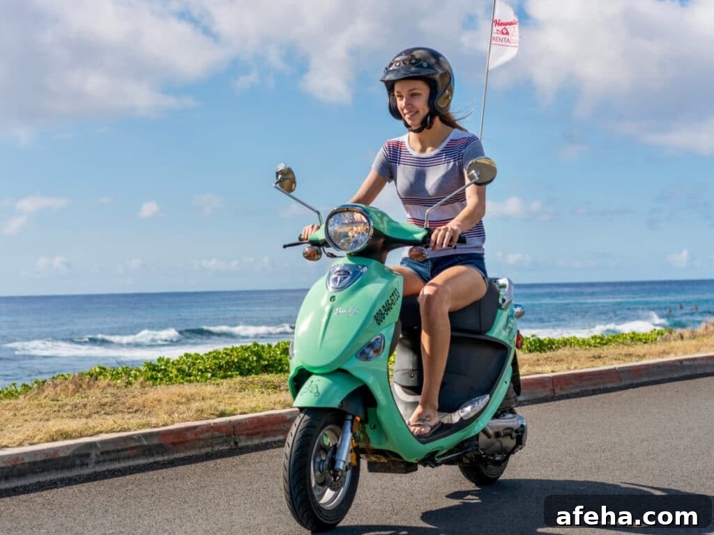 A solo rider on a aqua-blue moped rental from Hawaiian Style Rental, cruising the coastal area of O'ahu, Hawai'i.