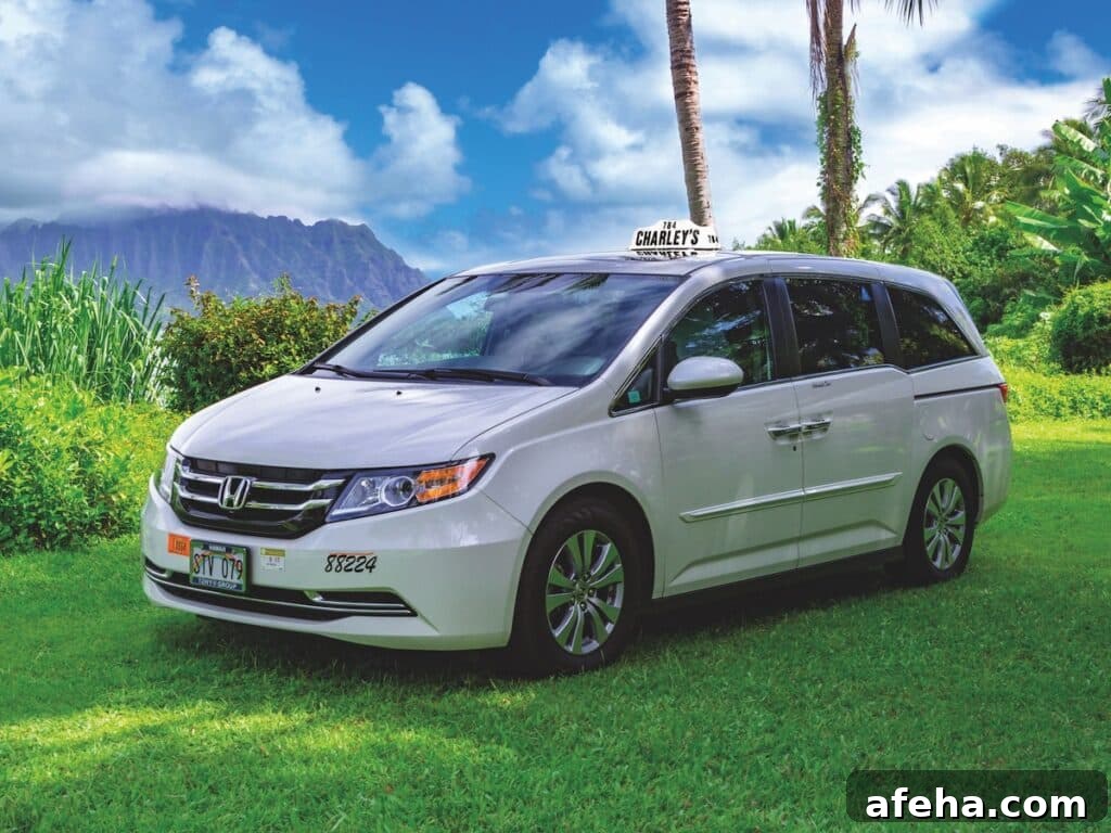 A white Charley's Taxi Honda Odyssey vehicle with a lush Oʻahu botanical garden backdrop.