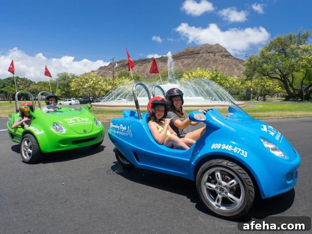 Two scoot coupe driving around the water feature in Diamond Head.