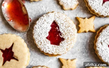 Close up of Strawberry Cardamom Linzer Cookies dusted with powdered sugar