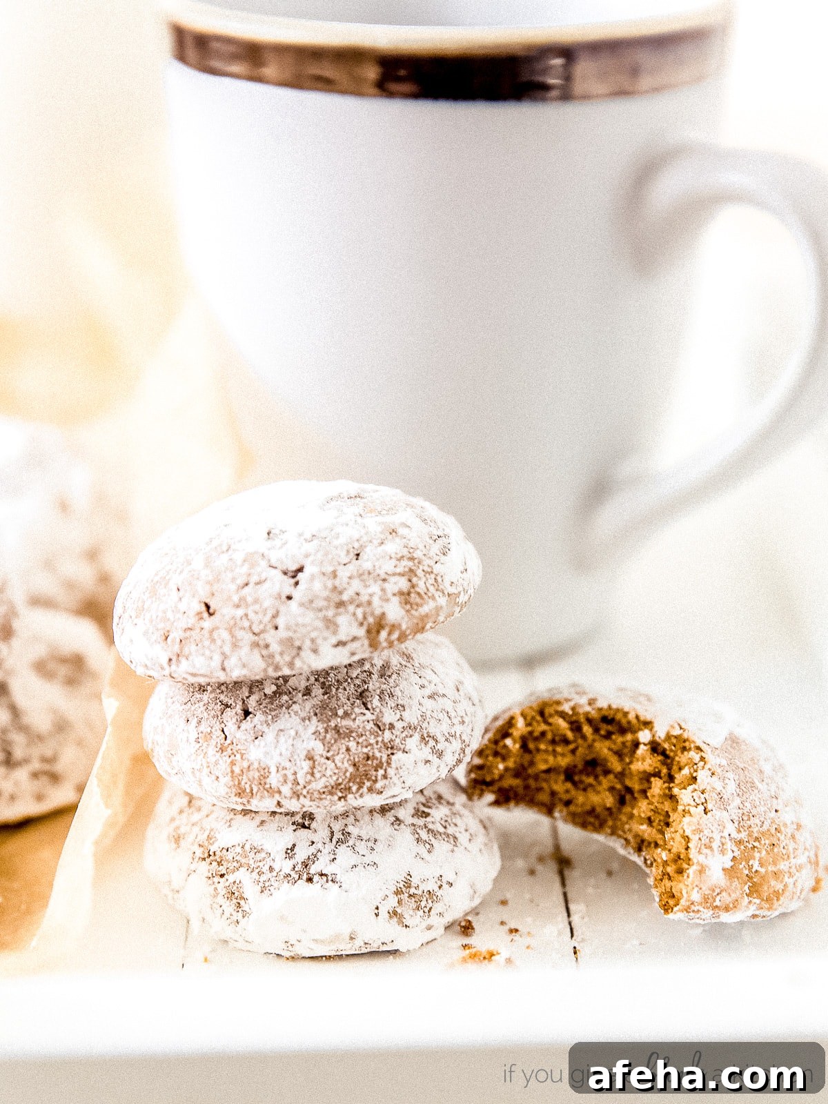 stack of pfeffernusse cookies on striped kitchen towels with anise stars