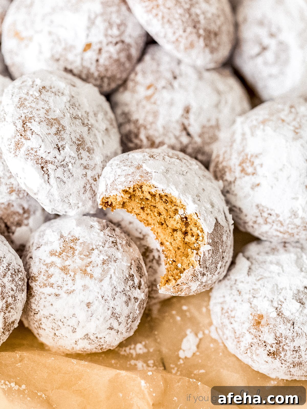 baked pfeffernusse on cookie sheet with parchment paper