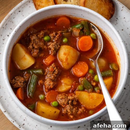 Hamburger soup served in a white bowl.