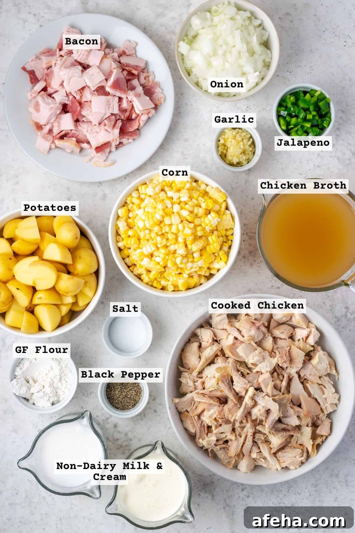Ingredients for chicken corn chowder on a white table.