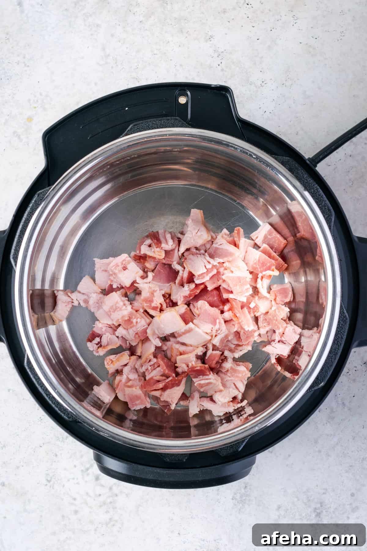 Pieces of raw bacon cooking in an instant pot.