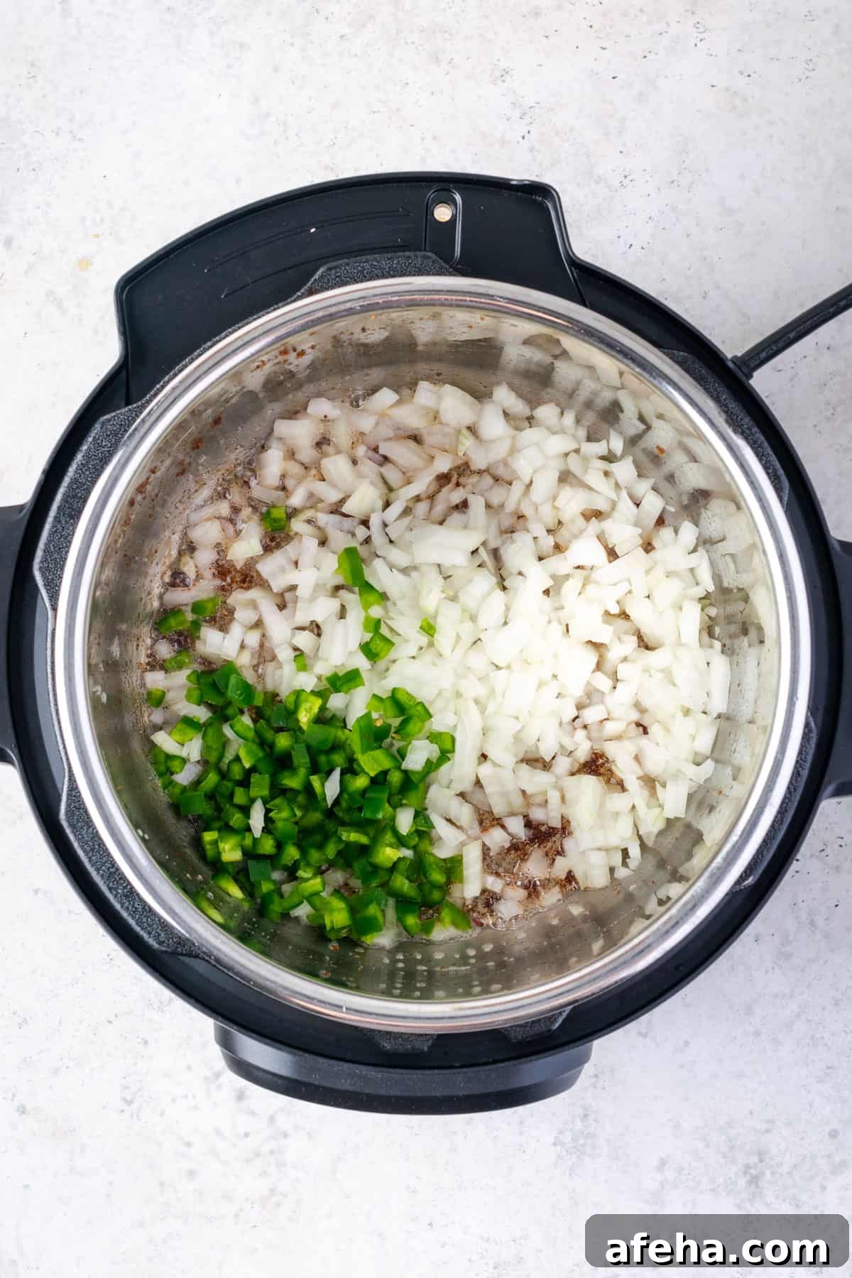 Diced onion and jalapeno added to the instant pot with the leftover bacon grease.