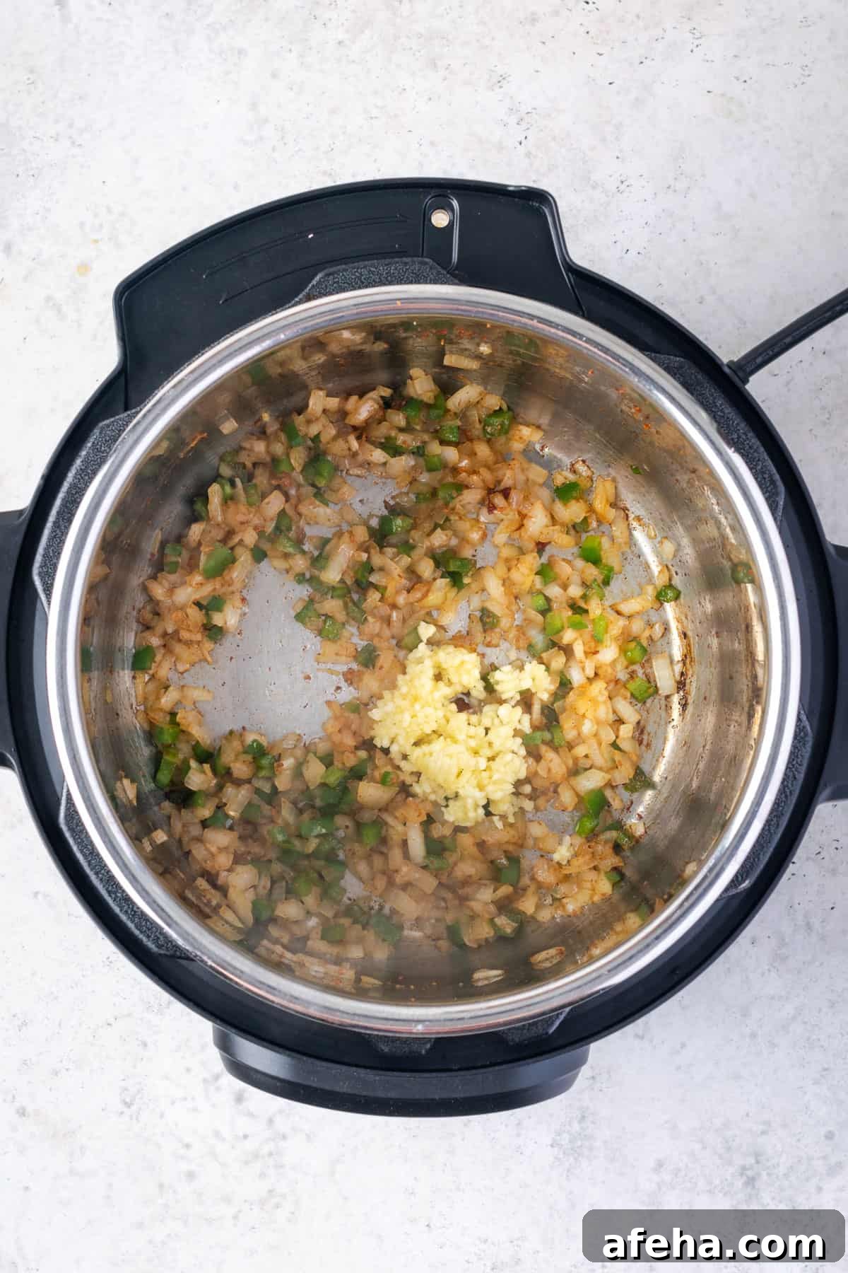 Minced garlic added to the instant pot with the sauteed vegetables.