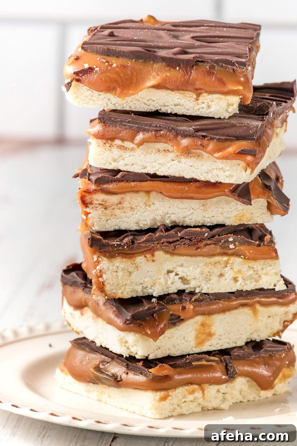 A stack of keto-friendly millionaire bars stacked on a white plate