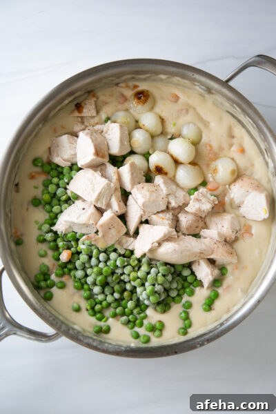 add chopped chicken, peas, pearl onions and herbs