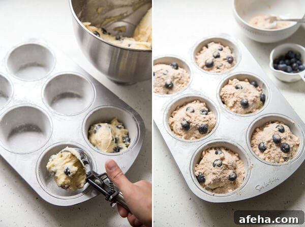 Adding blueberry muffin batter to a muffin pan