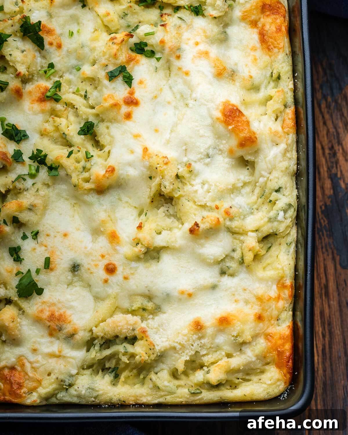 Black baking dish with Italian baked mashed potatoes.