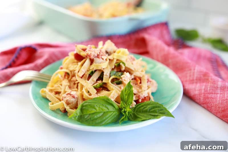 baked low carb pasta recipe on a plate with more baked feta pasta in the background in a casserole dish