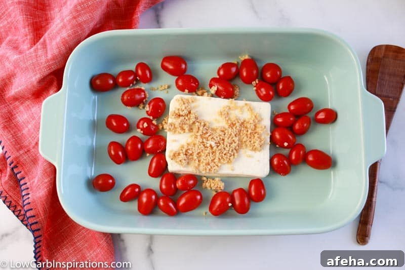 feta cheese block, cherry tomatoes and minced garlic in a casserole dish