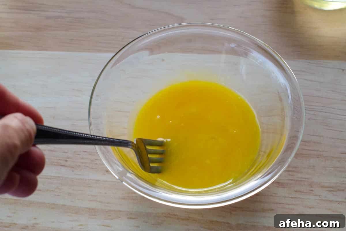 egg yolks being beaten with a fork