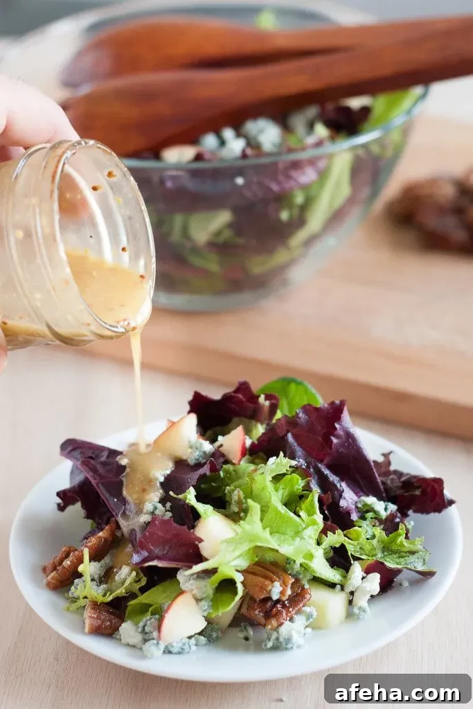 This salad is perfect for fall! Blue cheese crumbles, quick candied pecans, fresh apples, dark leafy greens, and an easy red wine vinaigrette. It's healthy fall comfort food! 