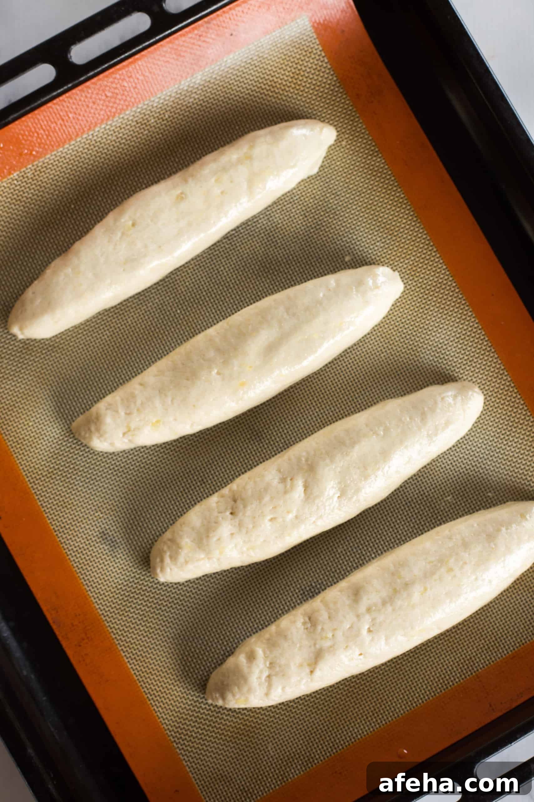 Baguette dough on silpat-lined baking sheet.