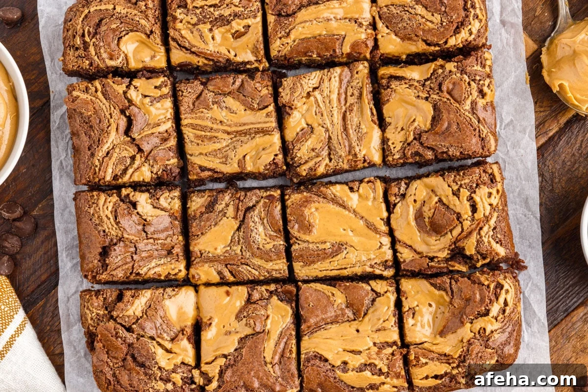 Peanut butter brownies cut into squares on parchment paper.