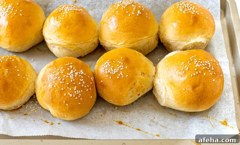 baked homemade burger buns on baking sheet