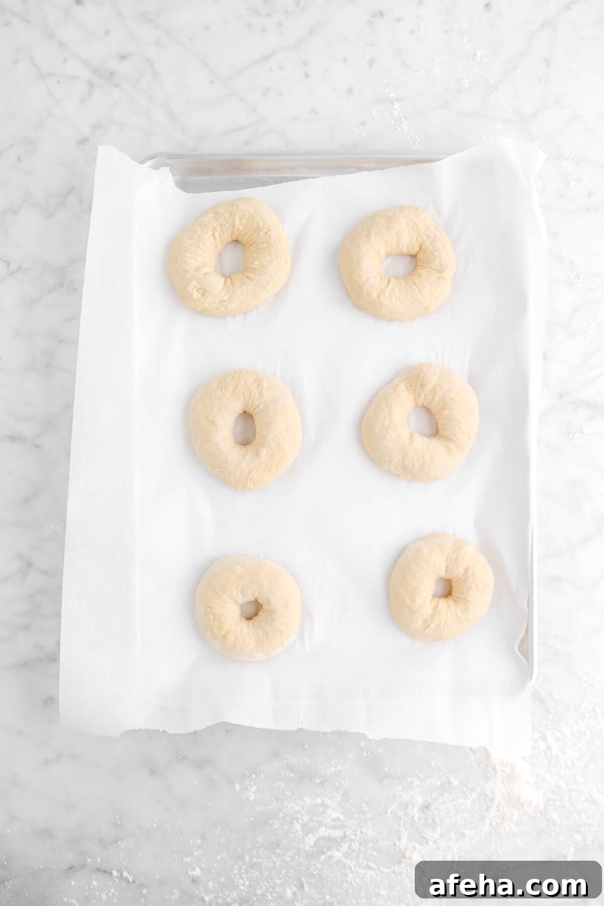 six bagels on lined sheet pan