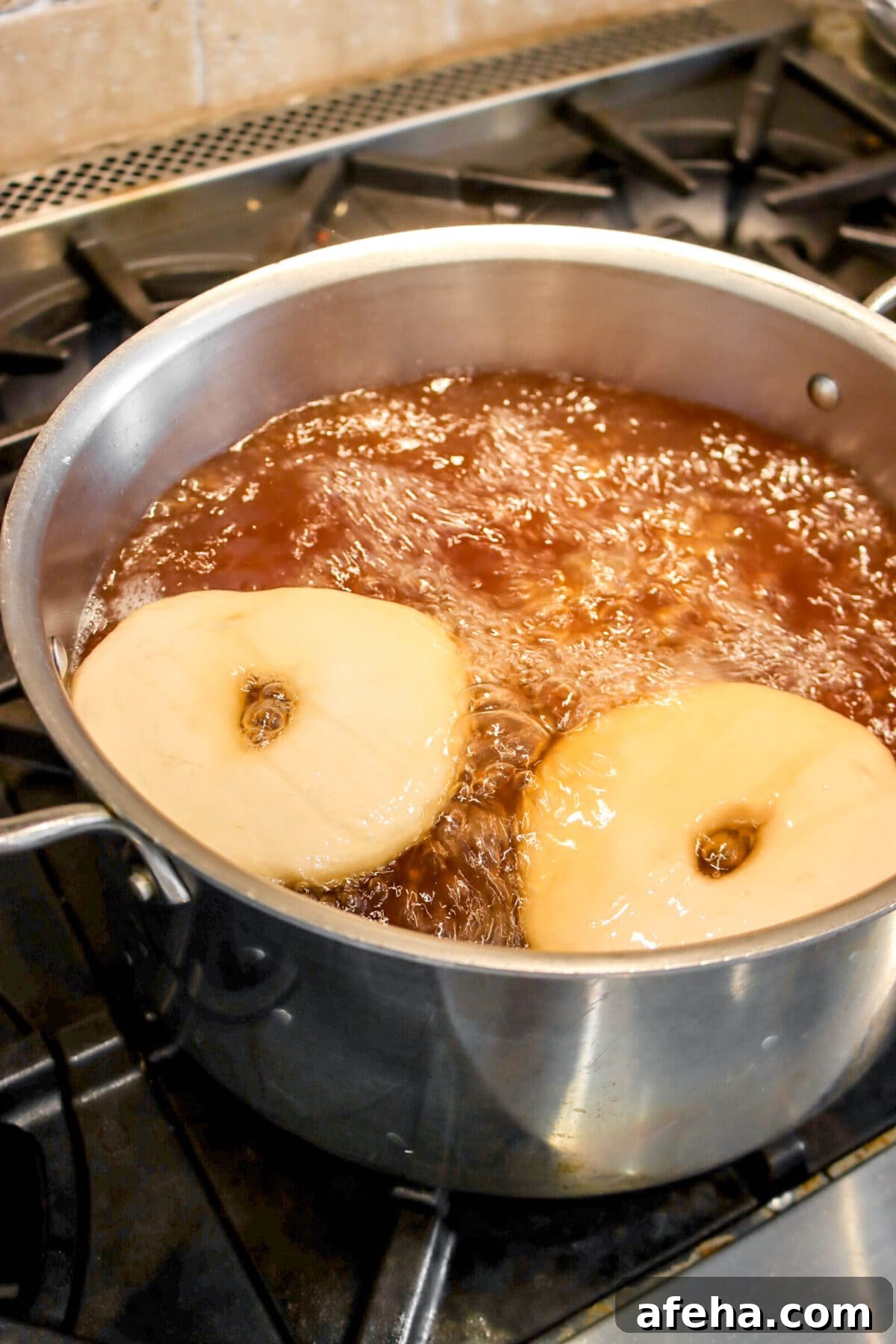 two bagels in pot of boiling water