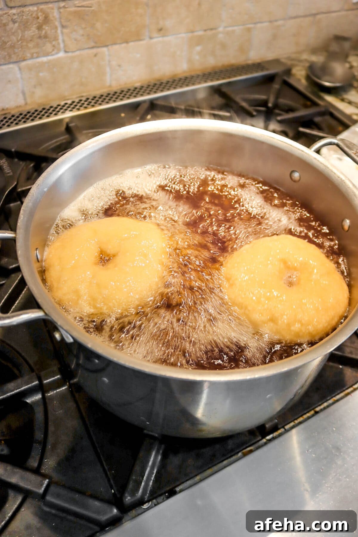 turned over bagels boiling in large stock pot