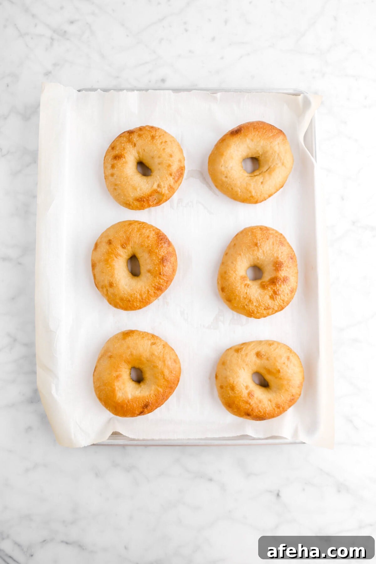 baked bagels on lined sheet pan